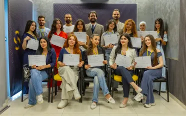 سومر حاتم، يقف في المنتصف مرتديًا بدلة رسمية، خلال إشرافه على الدورة.